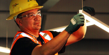 An electrical technician working on a job site.